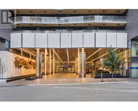 The image shows the front of a building with a large glass window and a sign that reads "REALTOR".