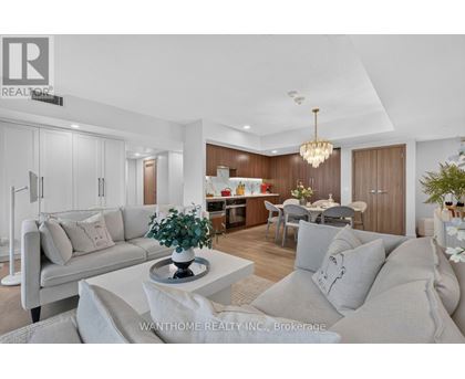 A modern living room with a grey sofa and a coffee table.