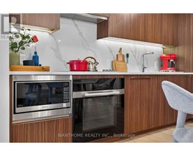 A modern kitchen with wooden cabinets and stainless steel appliances.