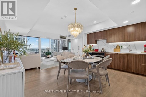 A modern dining room with a large table and chairs.