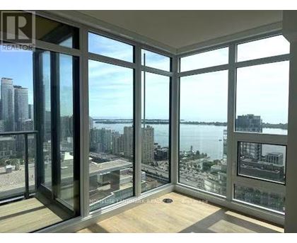 A room with a view of the city and water.