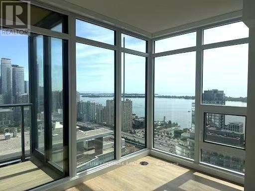 A room with a view of the city and water.