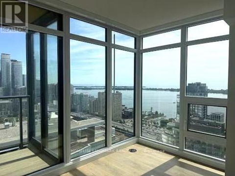 A room with a view of the city and water.