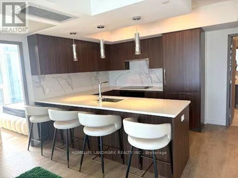 A kitchen with a marble countertop and white bar stools.