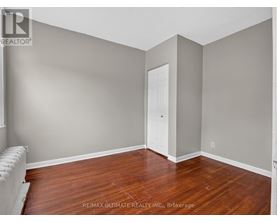 A room with a wooden floor and a white door.