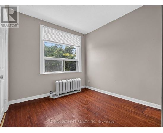 A room with a window and a radiator on the floor.