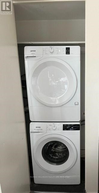 A white GE dryer is on top of a white GE washer.