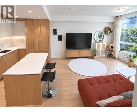 A modern living room with a red sofa and a television.