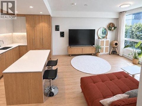 A modern living room with a red sofa and a television.