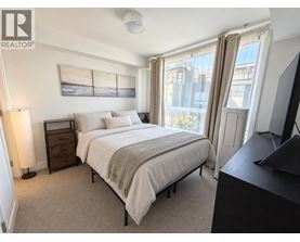 A bedroom with a large bed and a television.