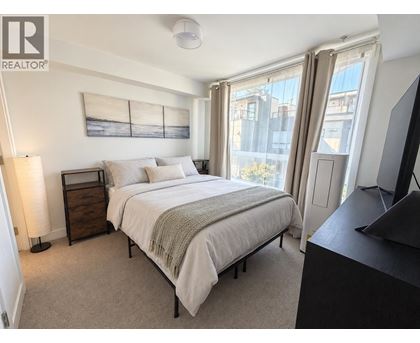 A bedroom with a large bed and a television.