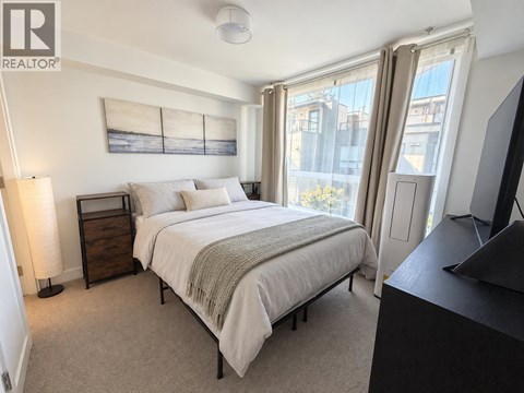 A bedroom with a large bed and a television.