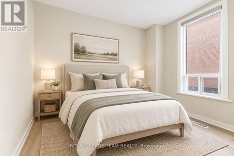 A bedroom with a bed, nightstands, and a painting on the wall.