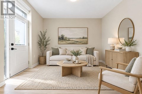A living room with a white couch, a coffee table, and a painting on the wall.