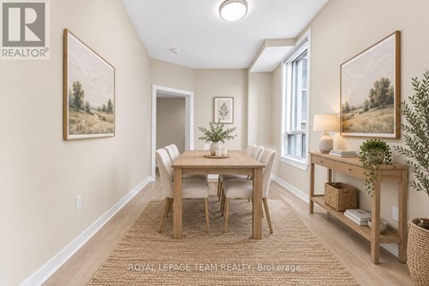 A dining room with a table set for four.