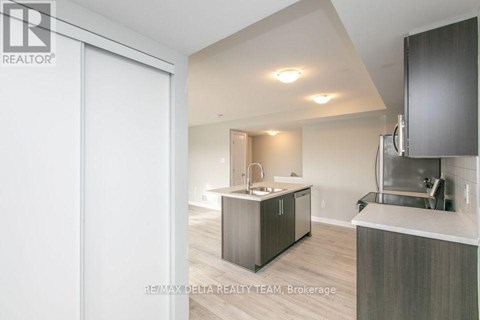 A modern kitchen with a sink and a refrigerator.