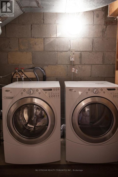 Two washing machines in a basement.