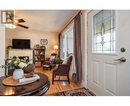 A living room with a fireplace, a chair, and a table.