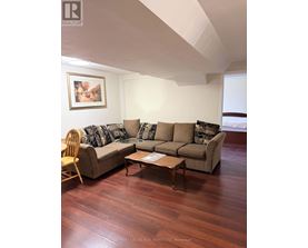 A living room with a couch, chair, and coffee table.