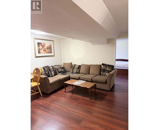 A living room with a couch, chair, and coffee table.