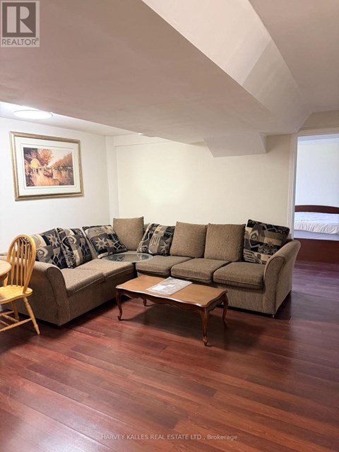 A living room with a couch, chair, and coffee table.