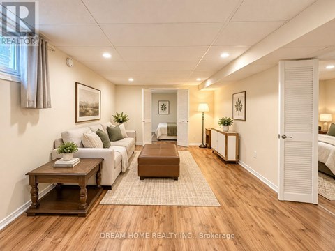 A well-lit living room with a white sofa, wooden coffee table, and a rug on the floor.