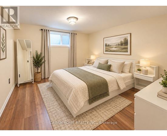 A bedroom with a large bed and a painting on the wall.