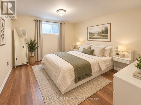 A bedroom with a large bed and a painting on the wall.