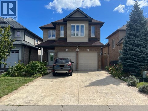 A house with a garage and a car parked in front.
