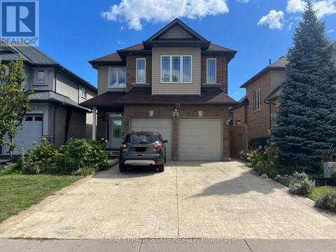 A house with a garage and a car parked in front.