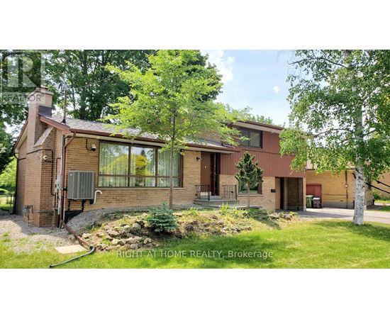 A house with a red brick exterior and a large front yard.