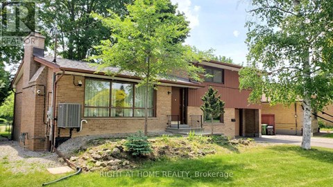 A house with a red brick exterior and a large front yard.