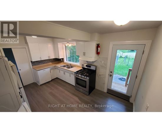 A kitchen with white cabinets and a black stove top oven.