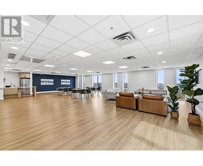 A spacious office with wooden floors and white walls.