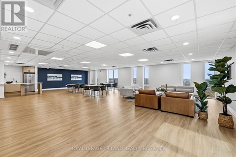 A spacious office with wooden floors and white walls.