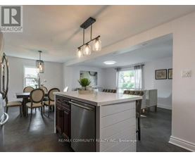 A modern kitchen with a dining table and chairs.