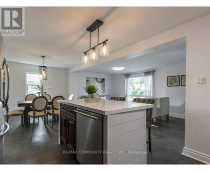 A modern kitchen with a dining table and chairs.