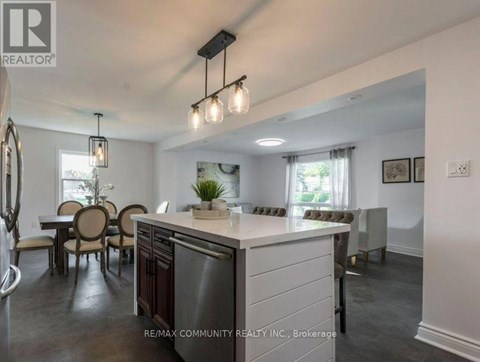 A modern kitchen with a dining table and chairs.