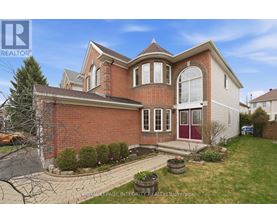 A large house with a red brick exterior and a white garage door.