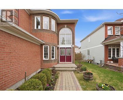 A house with a red brick exterior and a red door is for sale.
