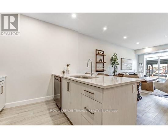 A modern kitchen with white cabinets and a large island.