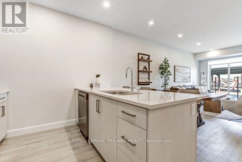 A modern kitchen with white cabinets and a large island.