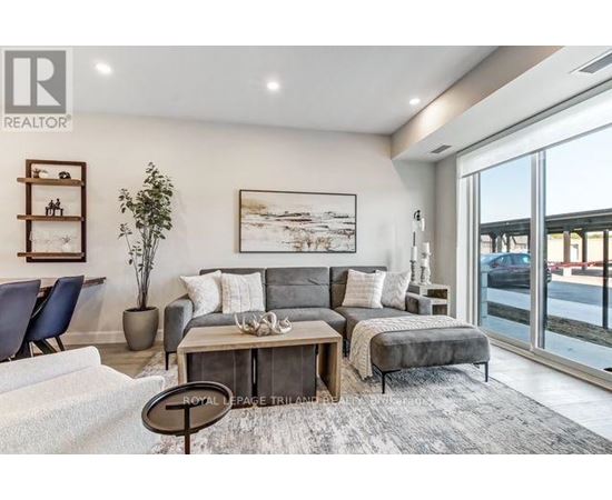 A living room with a grey couch and a coffee table.