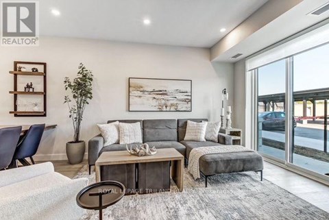 A living room with a grey couch and a coffee table.