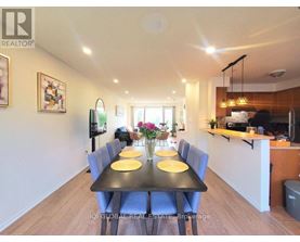 A dining room with a black table and blue chairs.