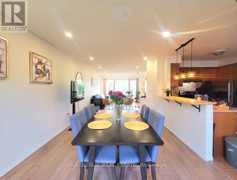 A dining room with a black table and blue chairs.