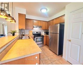 A kitchen with wooden cabinets and stainless steel appliances.