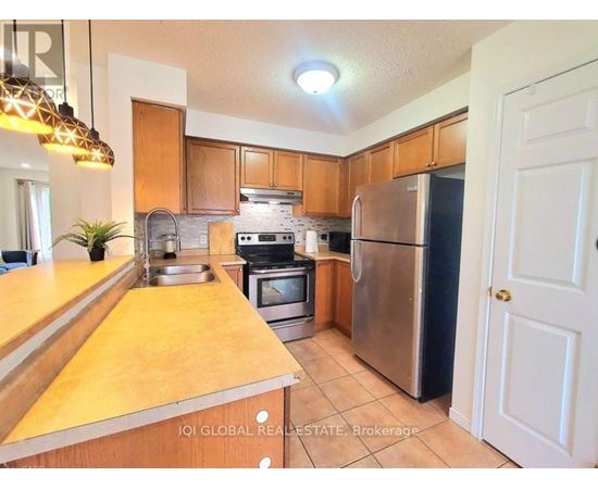 A kitchen with wooden cabinets and stainless steel appliances.