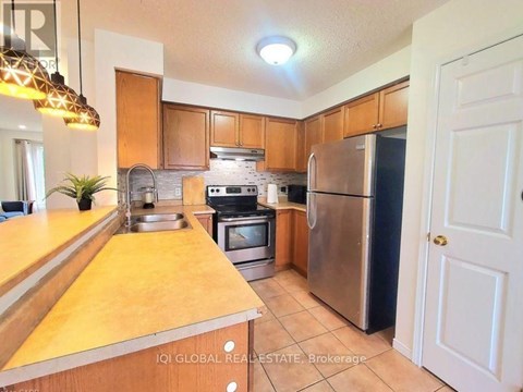 A kitchen with wooden cabinets and stainless steel appliances.