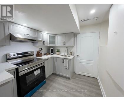 A kitchen with a stove top oven and a sink.